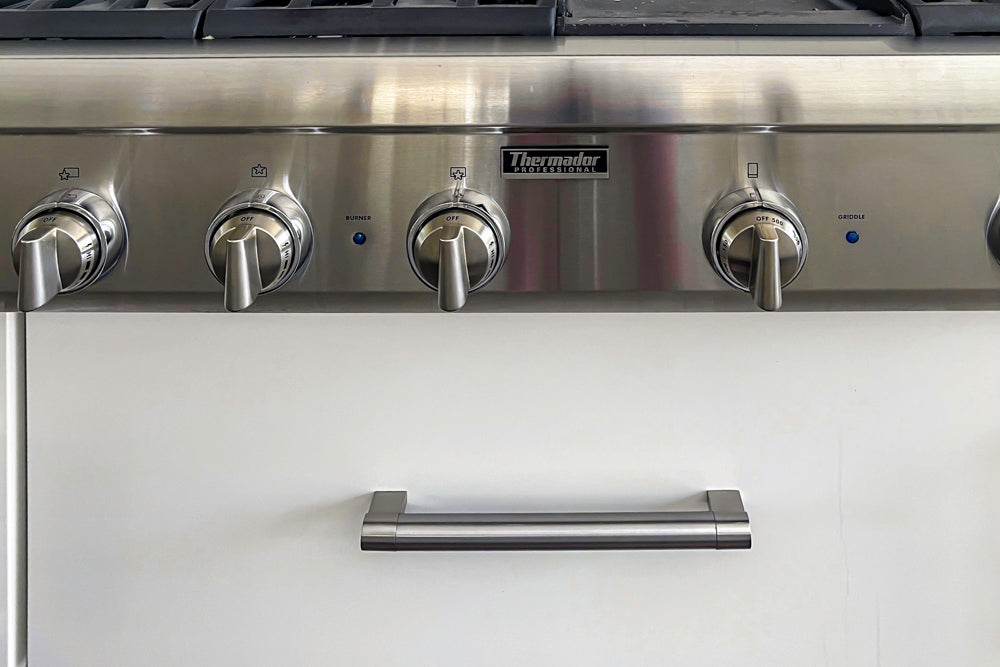 Transitional White Kitchen with Marble Waterfall Island and Thermador Appliances