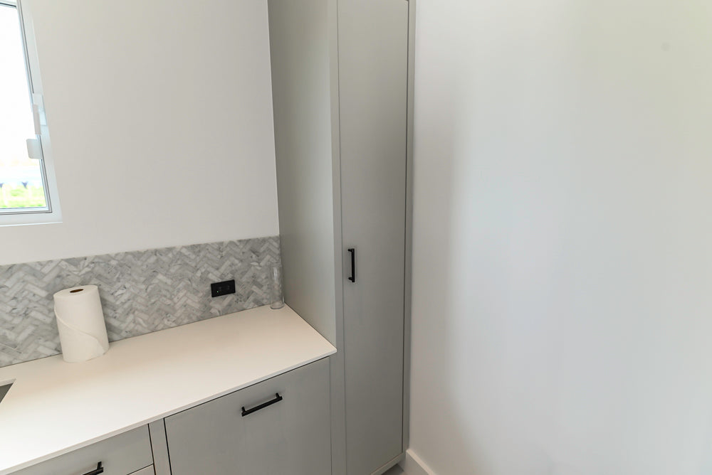 Custom Modern Light Grey Pantry with White Stone Countertops and Stainless Steel Sink