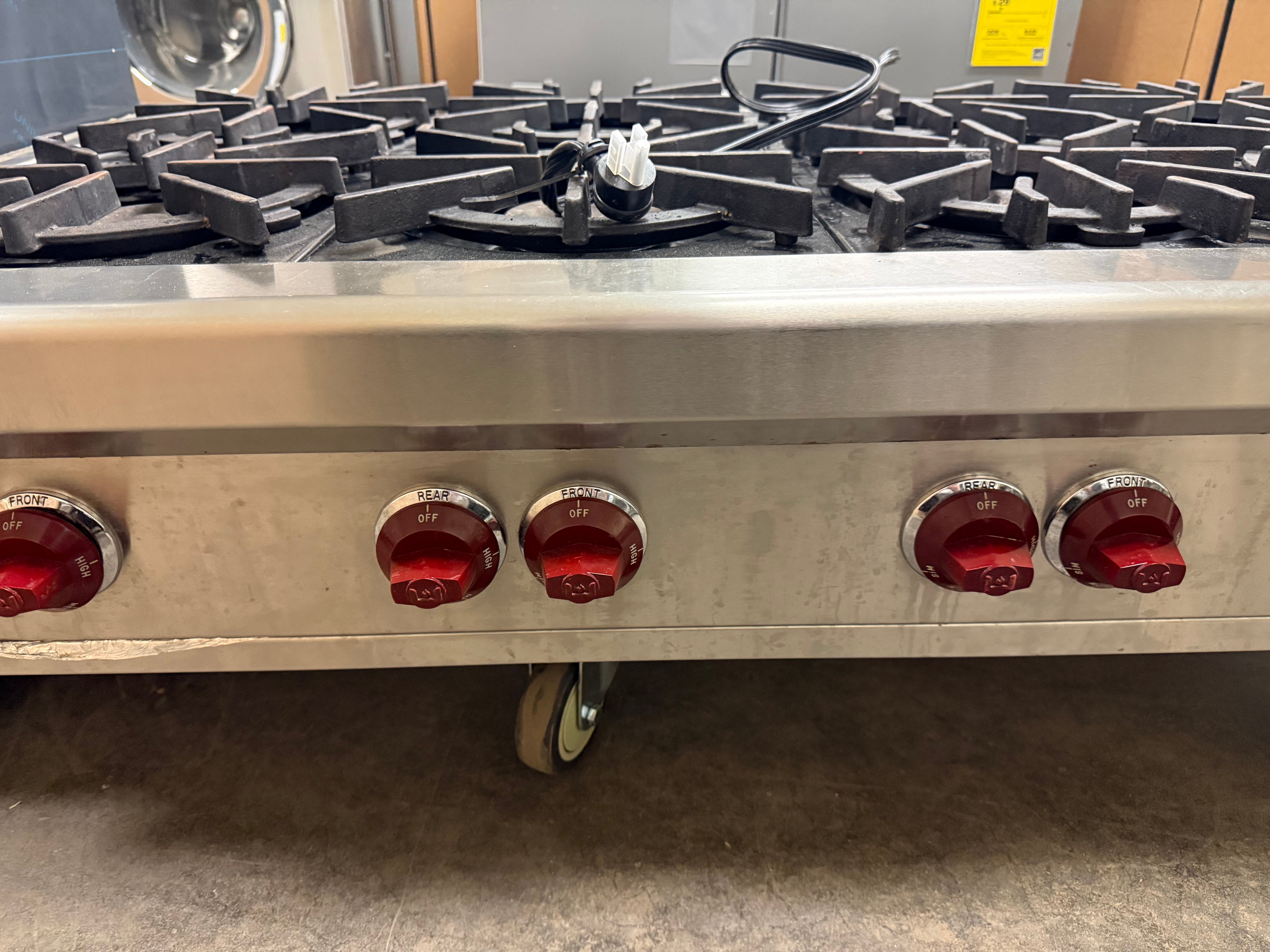Professional kitchen setup featuring Wolf 48 inch 8-burner gas rangetop