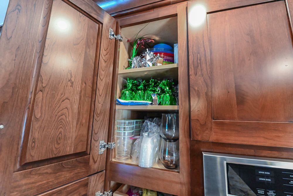 Kraftmaid Transitional Dark Wooden Kitchen with Marble Countertops and GE Monogram Appliances