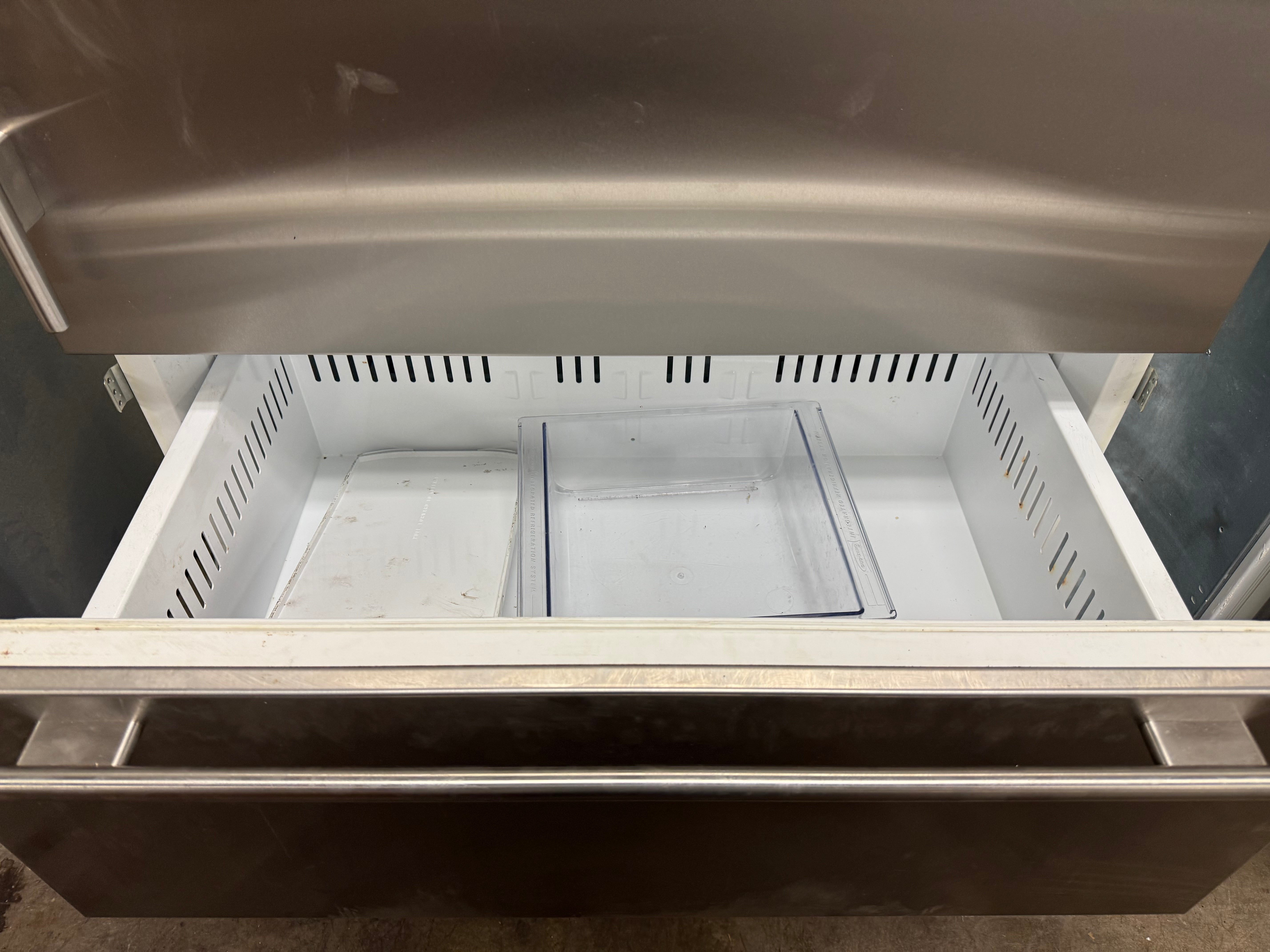 The pull-out bottom freezer drawer of the Sub-Zero 736TCI, showing the dual-tier storage baskets and automatic icemaker.