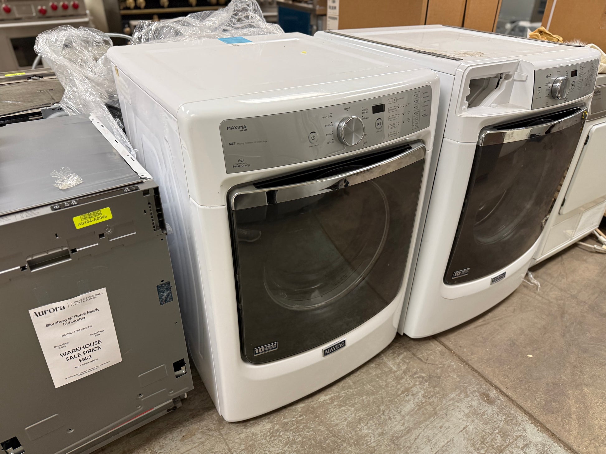 White washer and dryer set in a warehouse setting