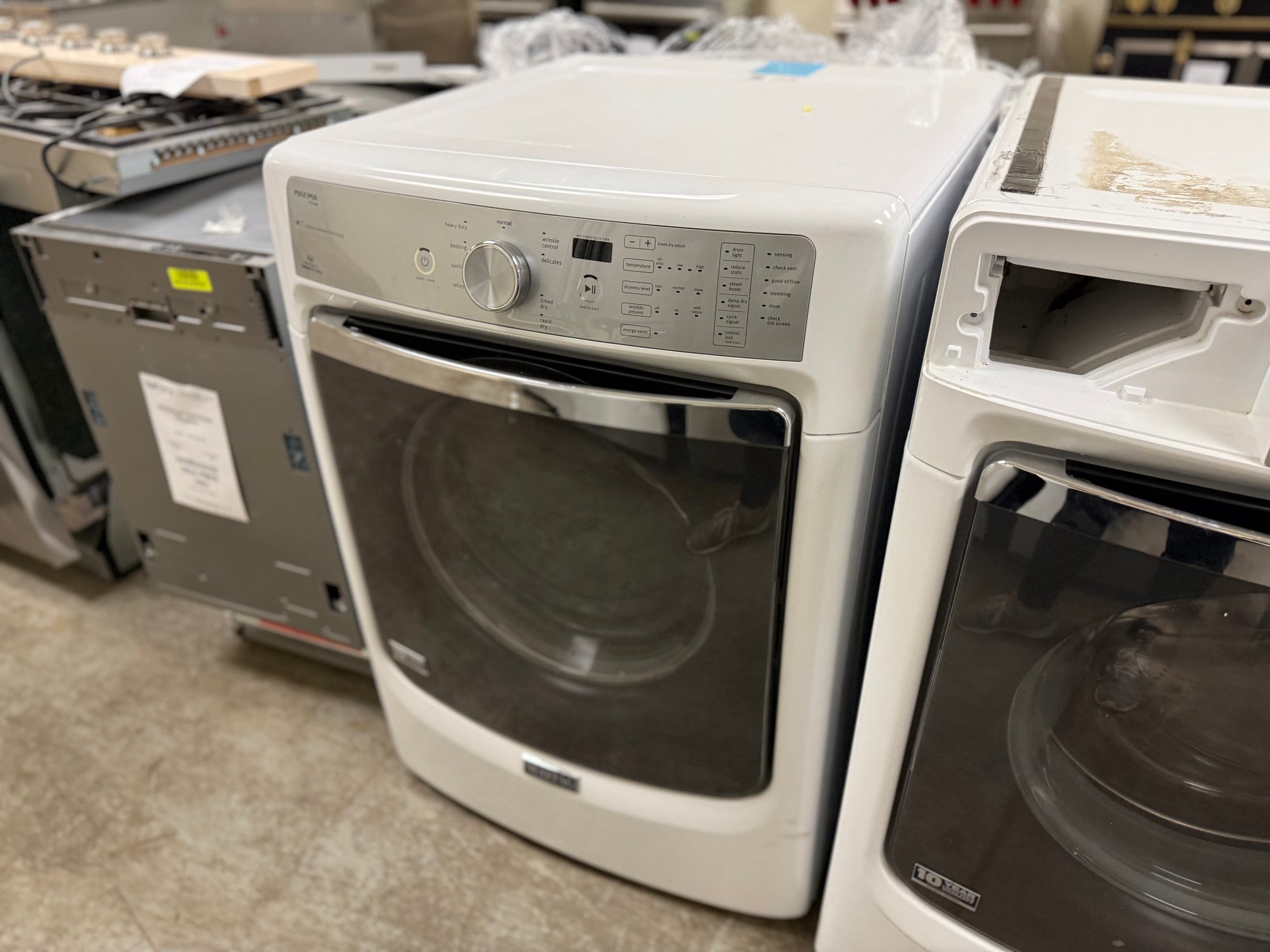 White dryer with black glass door in a showroom setting