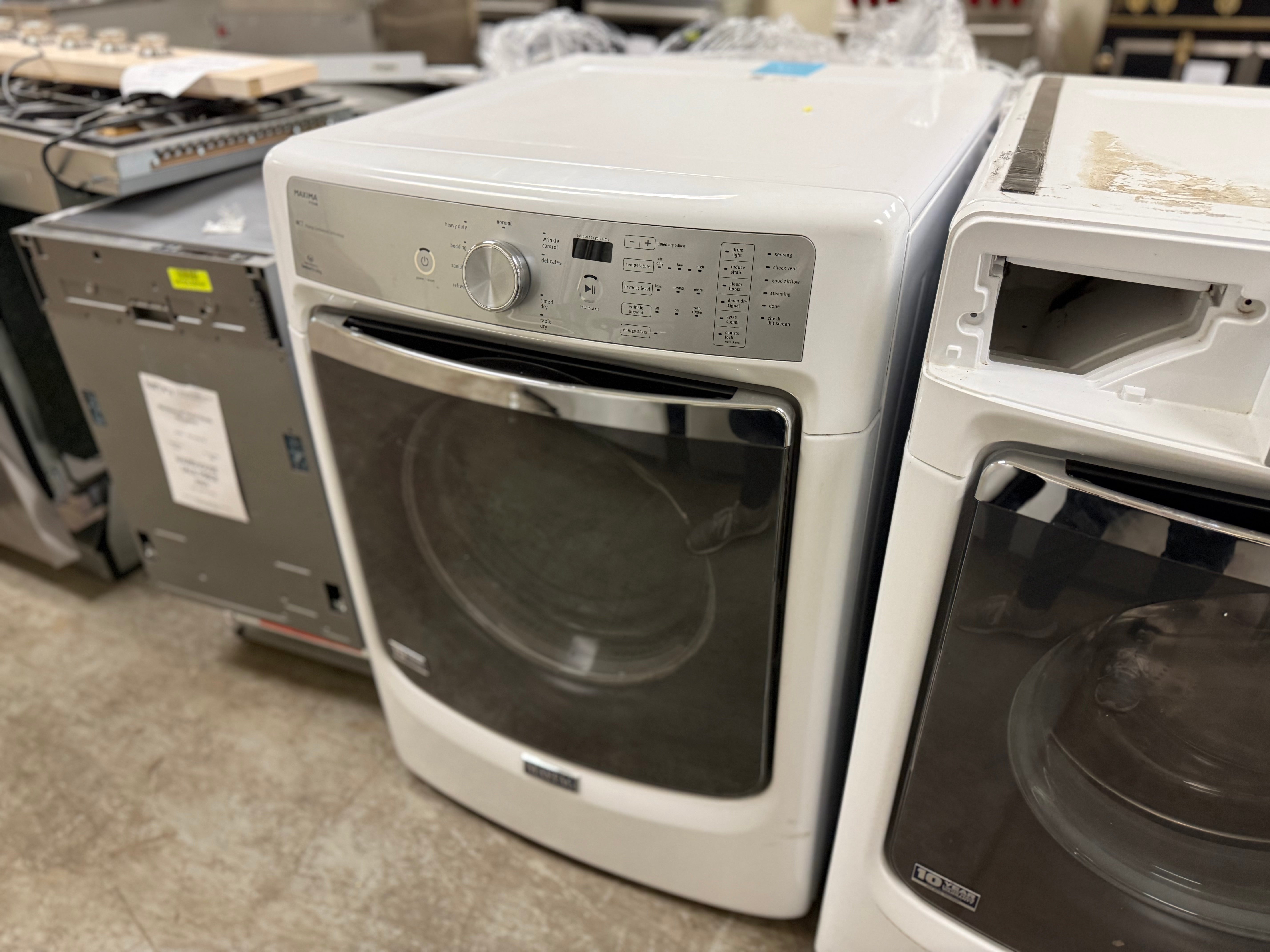 White dryer with black glass door in a showroom setting