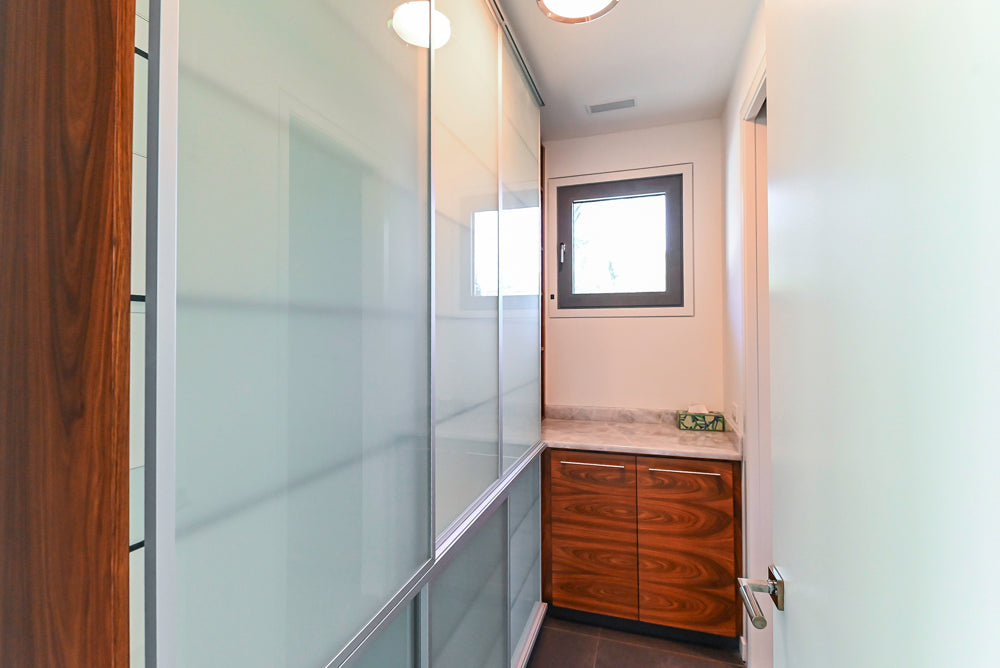 Custom Modern Tigerwood & Glass Paned Butler's Pantry with Marble Countertops