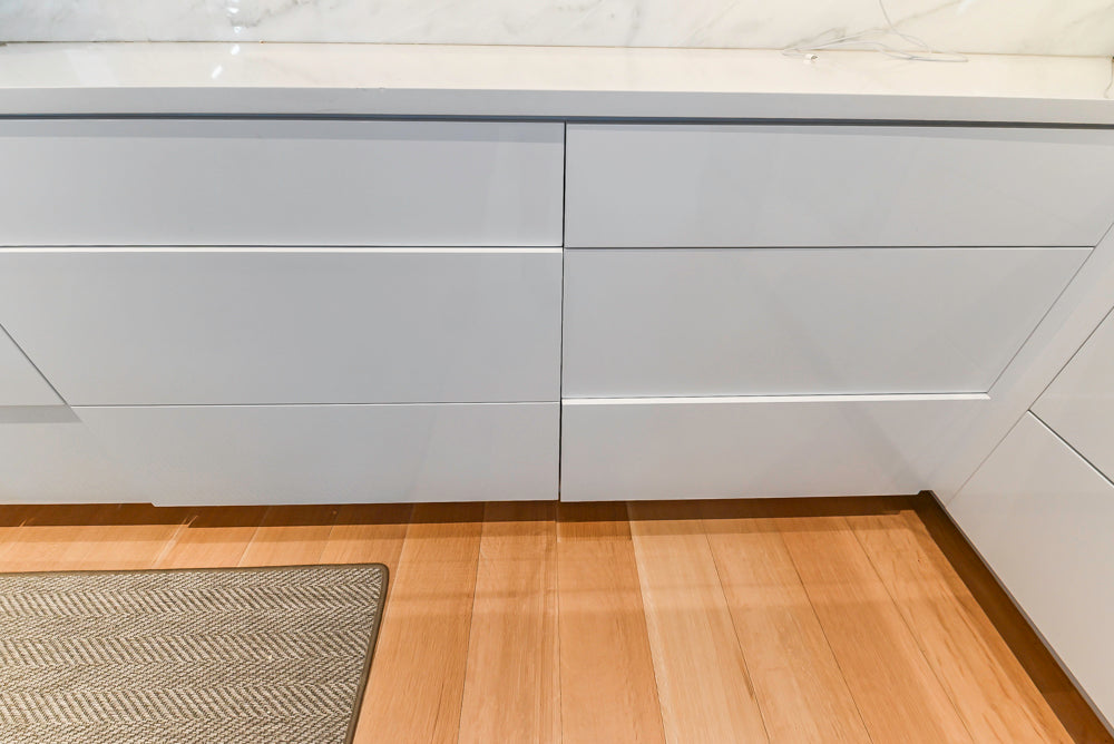 Brubaker Modern White Lacquered Kitchen with Waterfall Island and Stone Countertops