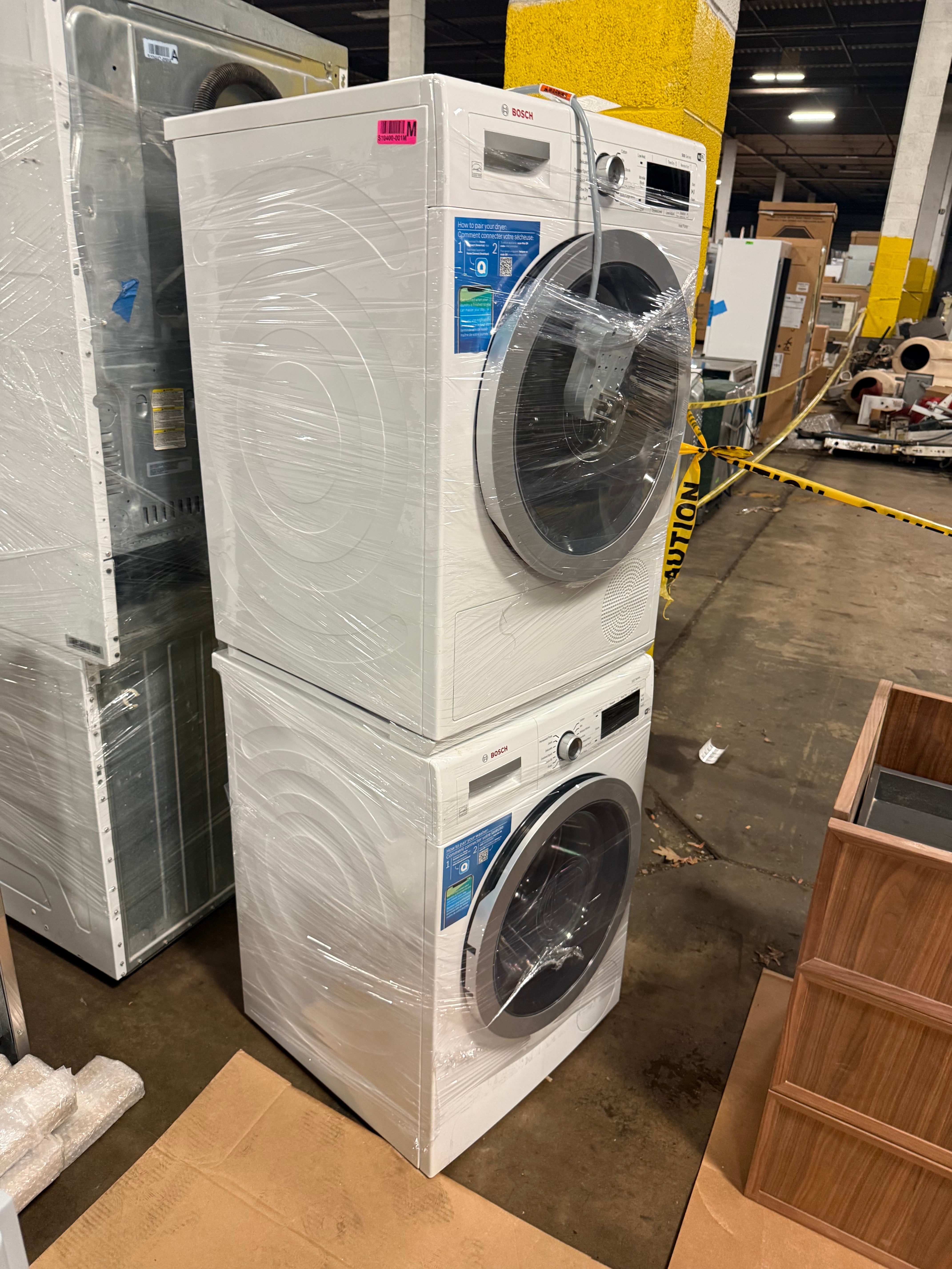 Bosch 500 Series 24 inch compact stacked washer and ventless electric dryer in classic white front view