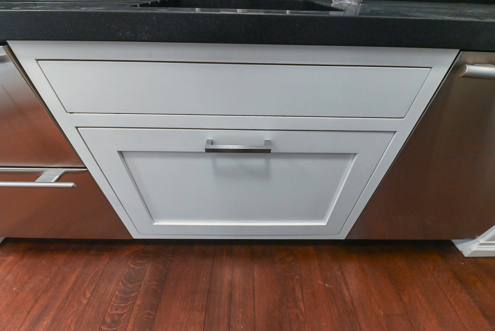 Gray kitchen cabinet with black countertop and wooden floor