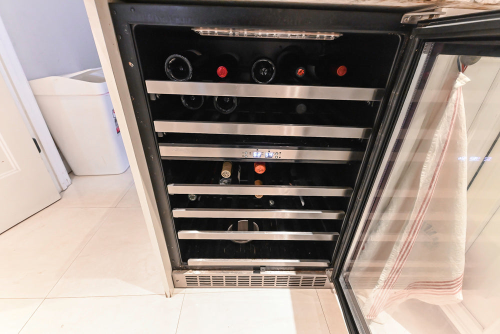 Candelight Traditional Off White Kitchen with Island and Monogram Appliances