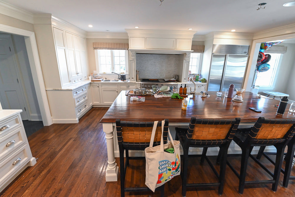 High-end white kitchen island with natural marble top by Plain & Fancy