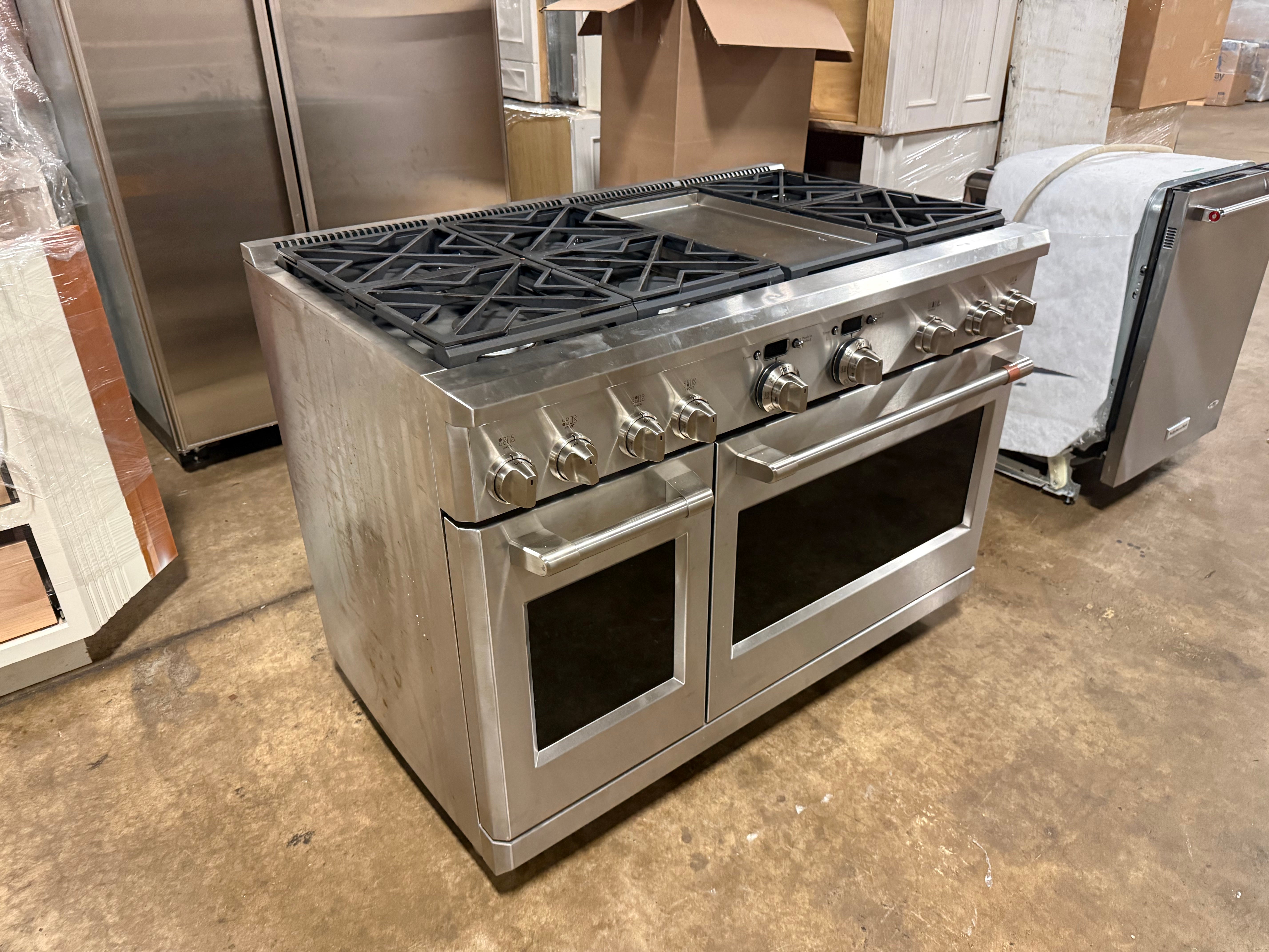 Premium Cafe 48 inch stainless steel professional range with double oven doors open showing blue porcelain interior
