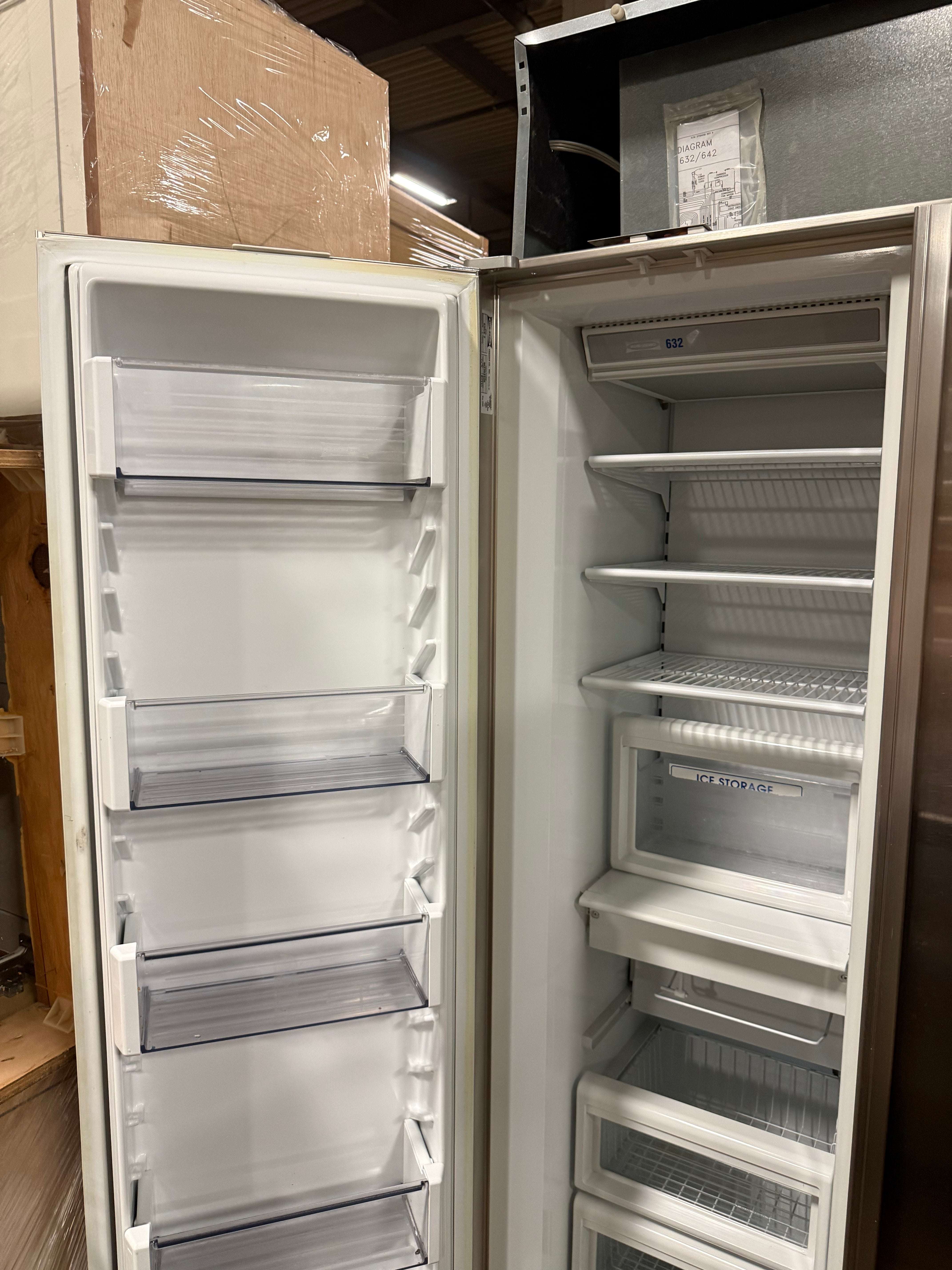 Open doors of a 48 inch Sub-Zero refrigerator showing glass shelves and dual refrigeration interior