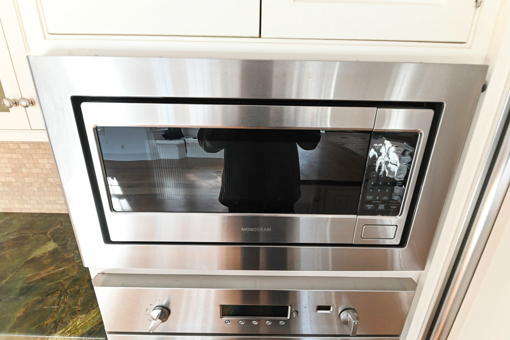 Stainless steel oven and microwave combo in a kitchen setting