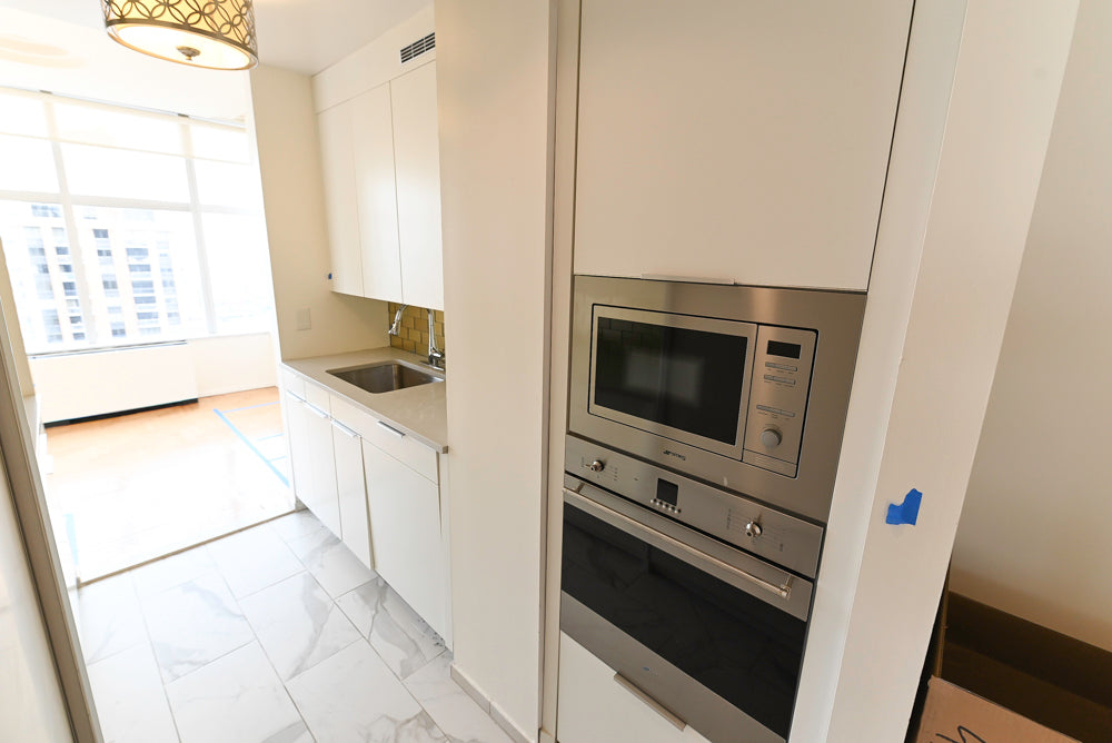 Leicht Modern Off White Kitchenette with Quartz Countertops & Smeg Appliances