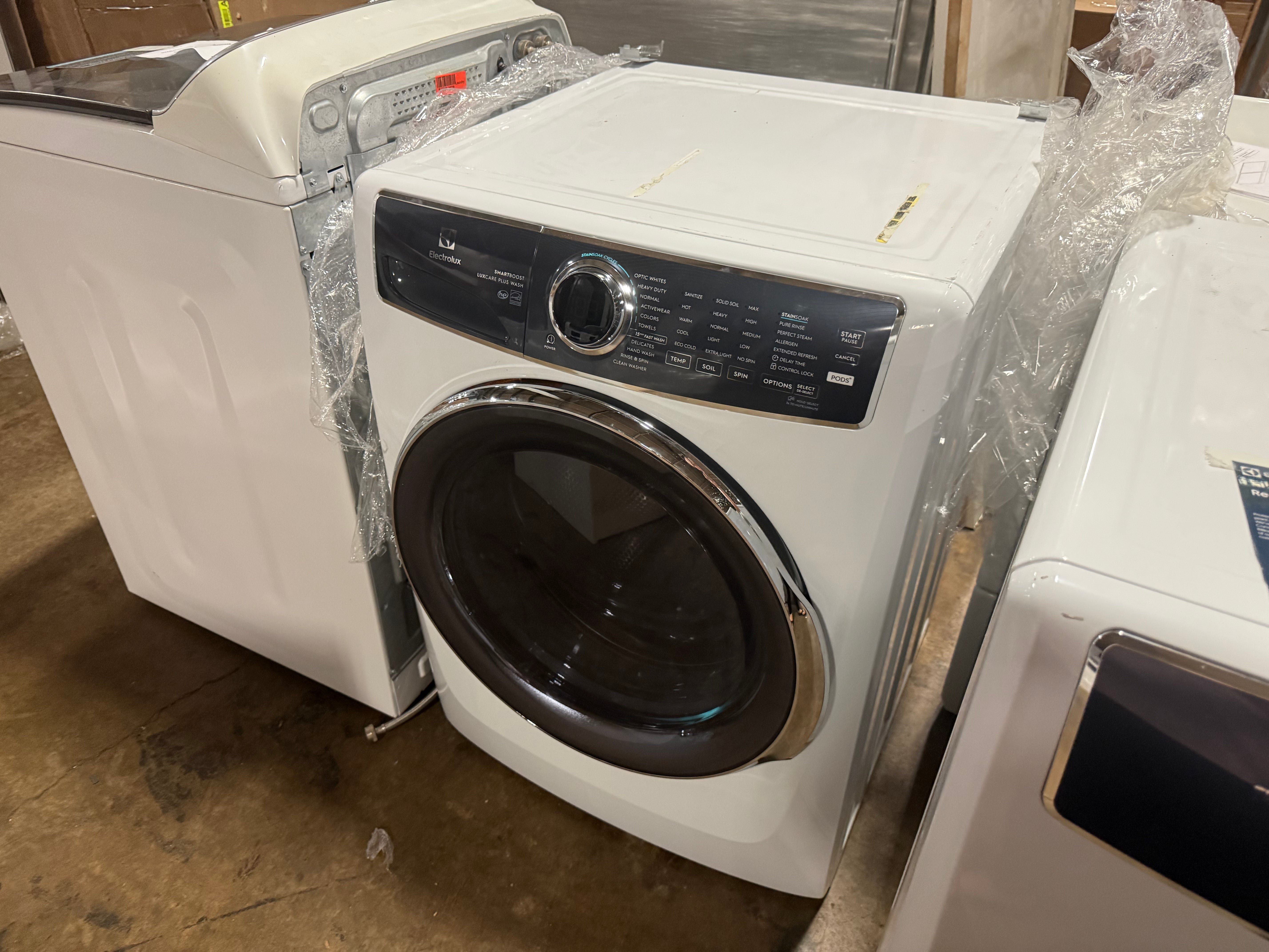 Luxury high efficiency laundry appliance showing open door and premium stainless steel inner washing drum