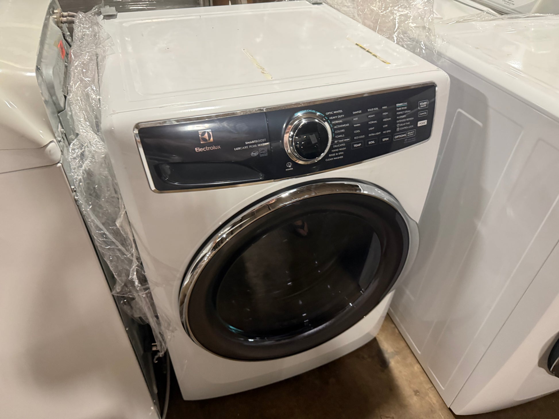 Electrolux front load washing machine with adaptive pod dispenser drawer pulled open