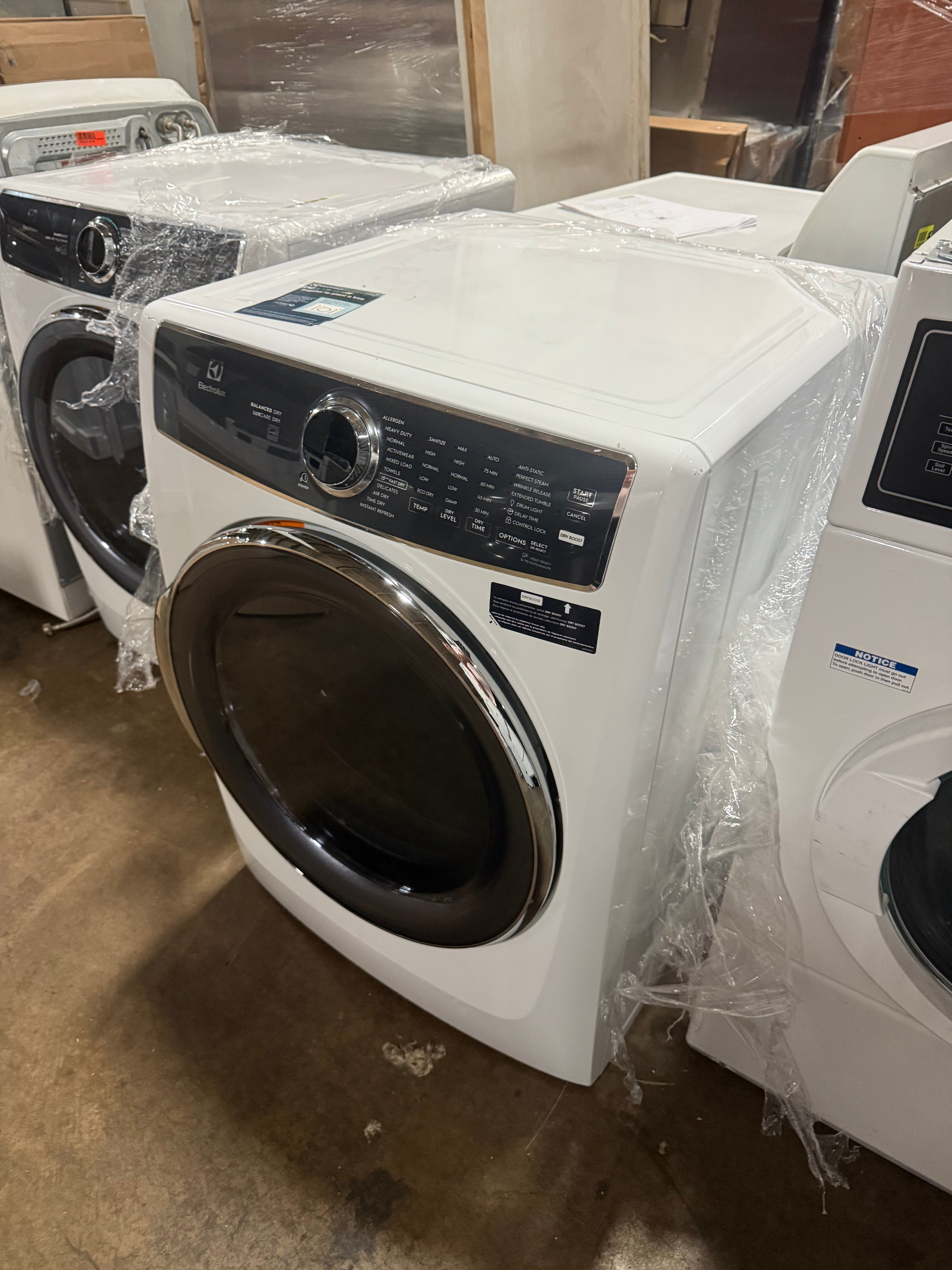 Luxury high efficiency electric laundry dryer showing open door and illuminated high capacity interior drum
