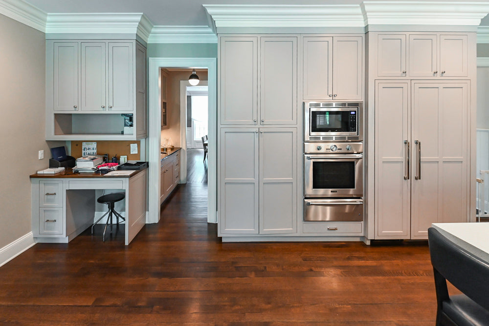 Pre owned Plain and Fancy luxury custom kitchen showing tall pantry towers and integrated fridge