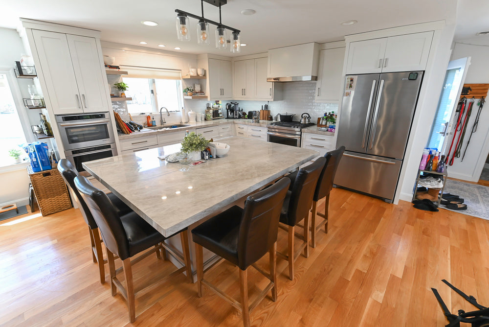 Complete custom kitchen with large social island and premium stone countertops