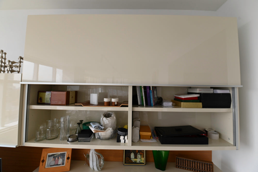 Shelving unit with various items on a white wall