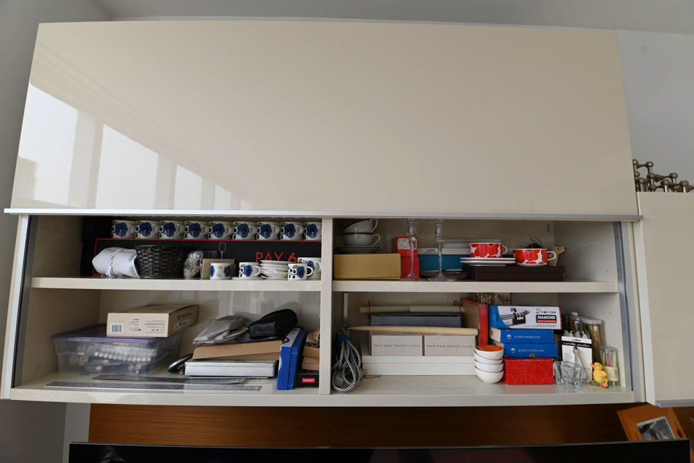 Open cabinet with various items on shelves