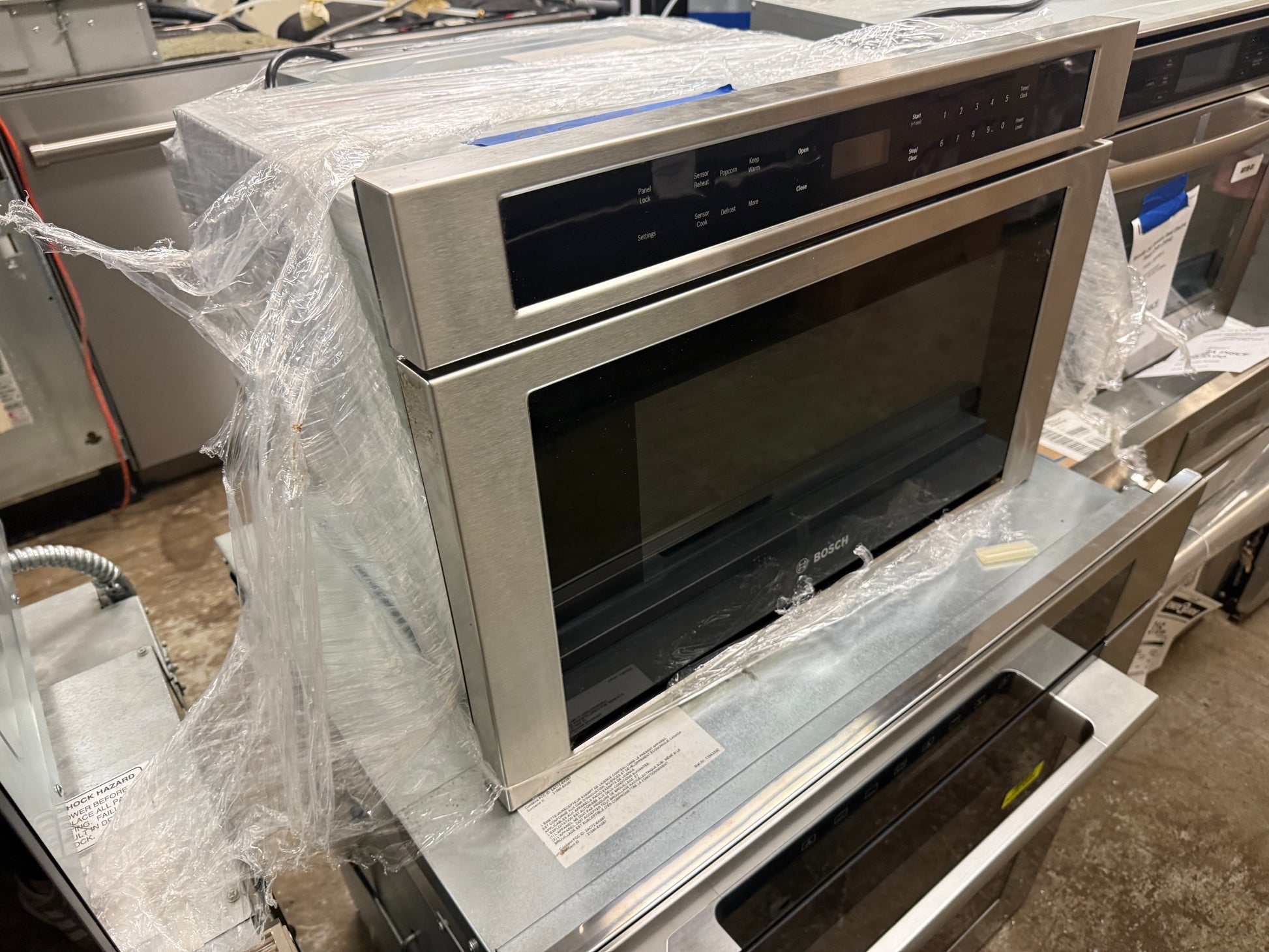 Luxury 24 inch island microwave drawer automatically glided open showing wide internal cavity