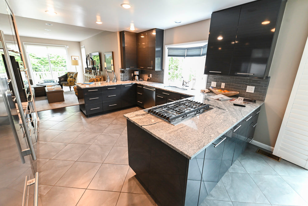 European style frameless black matte cabinetry with integrated appliance suite