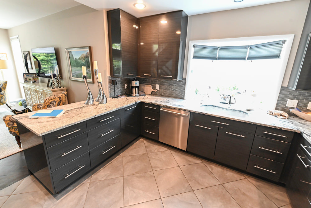 Pre-owned UltraCraft black slab door contemporary kitchen layout