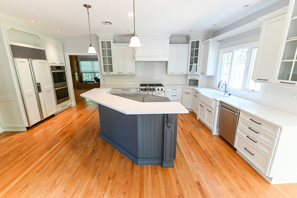 Luxury custom painted white inset cabinets with integrated appliances and wood side pantry