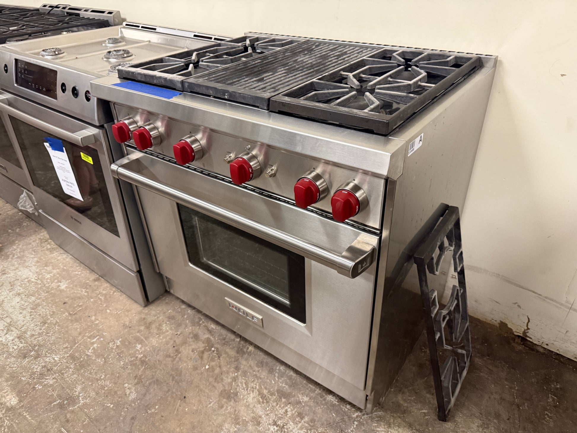 Pre owned Wolf 36 inch pro range open door showing large oven cavity with cobalt blue porcelain interior