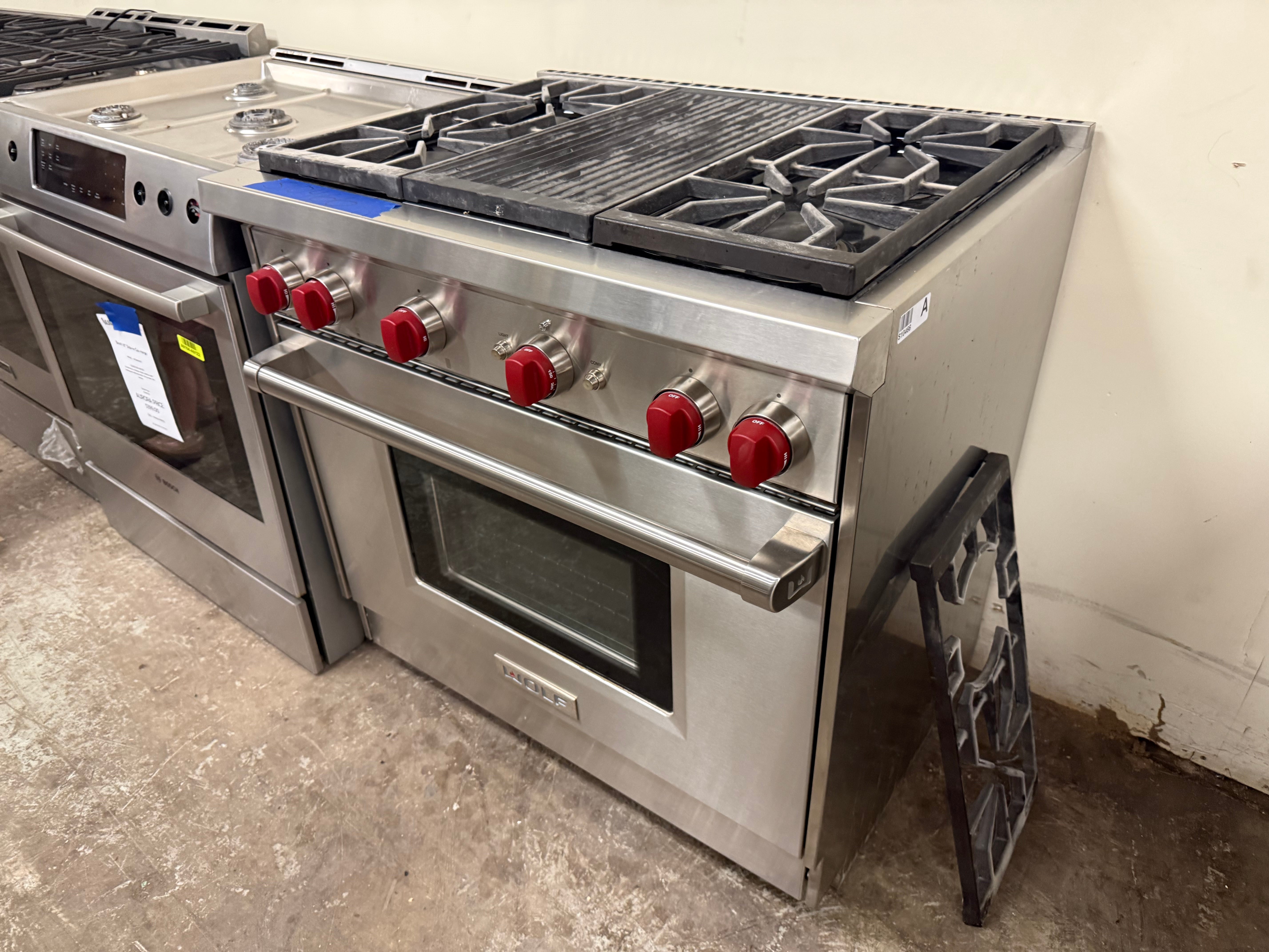 Pre owned Wolf 36 inch pro range open door showing large oven cavity with cobalt blue porcelain interior