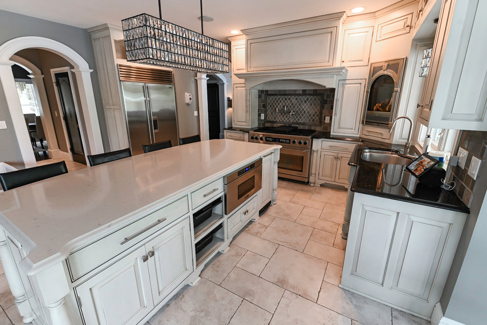 Luxury inset white cabinetry kitchen with Dacor gas rangetop and double wall ovens