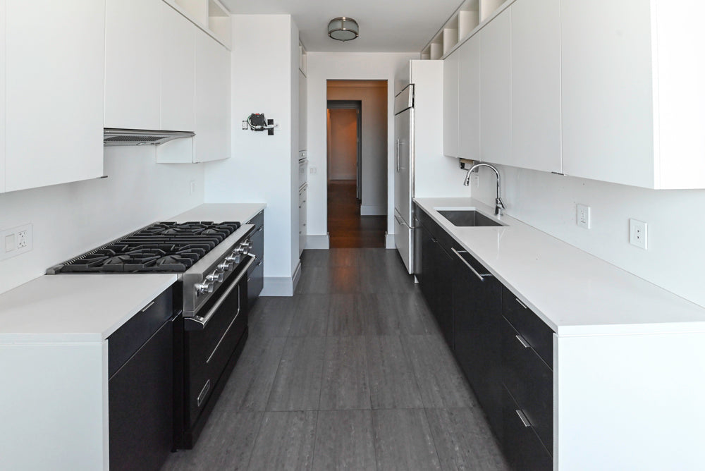 The Mercer modern two tone black and white luxury kitchen cabinetry package full view with integrated appliances