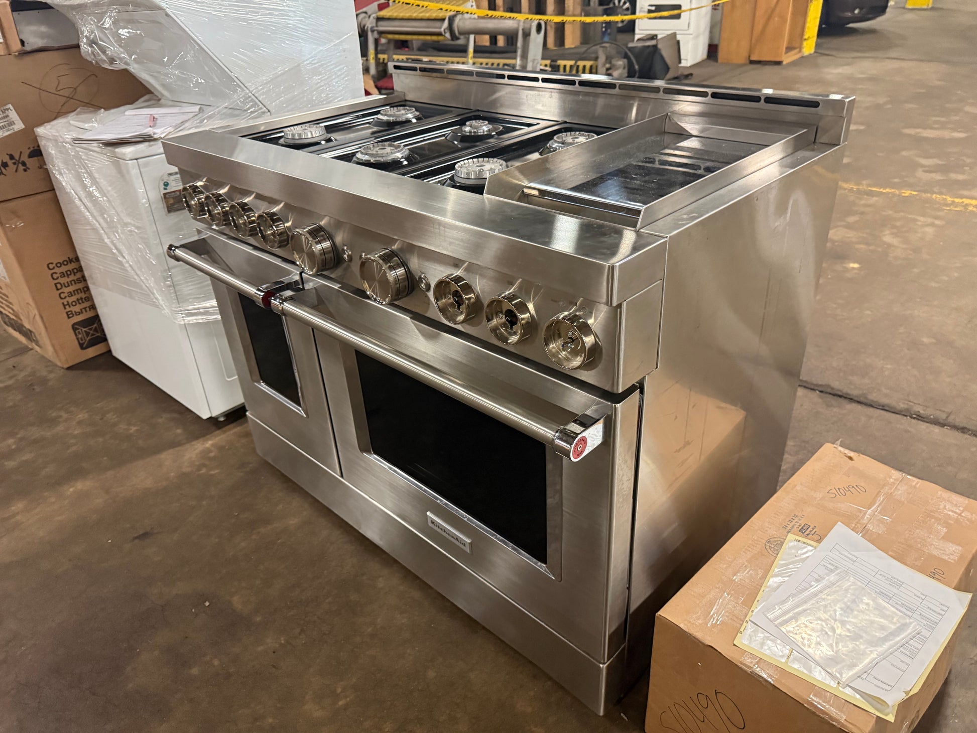 re owned KitchenAid 48 inch pro range open dual doors showing cobalt blue porcelain interiors