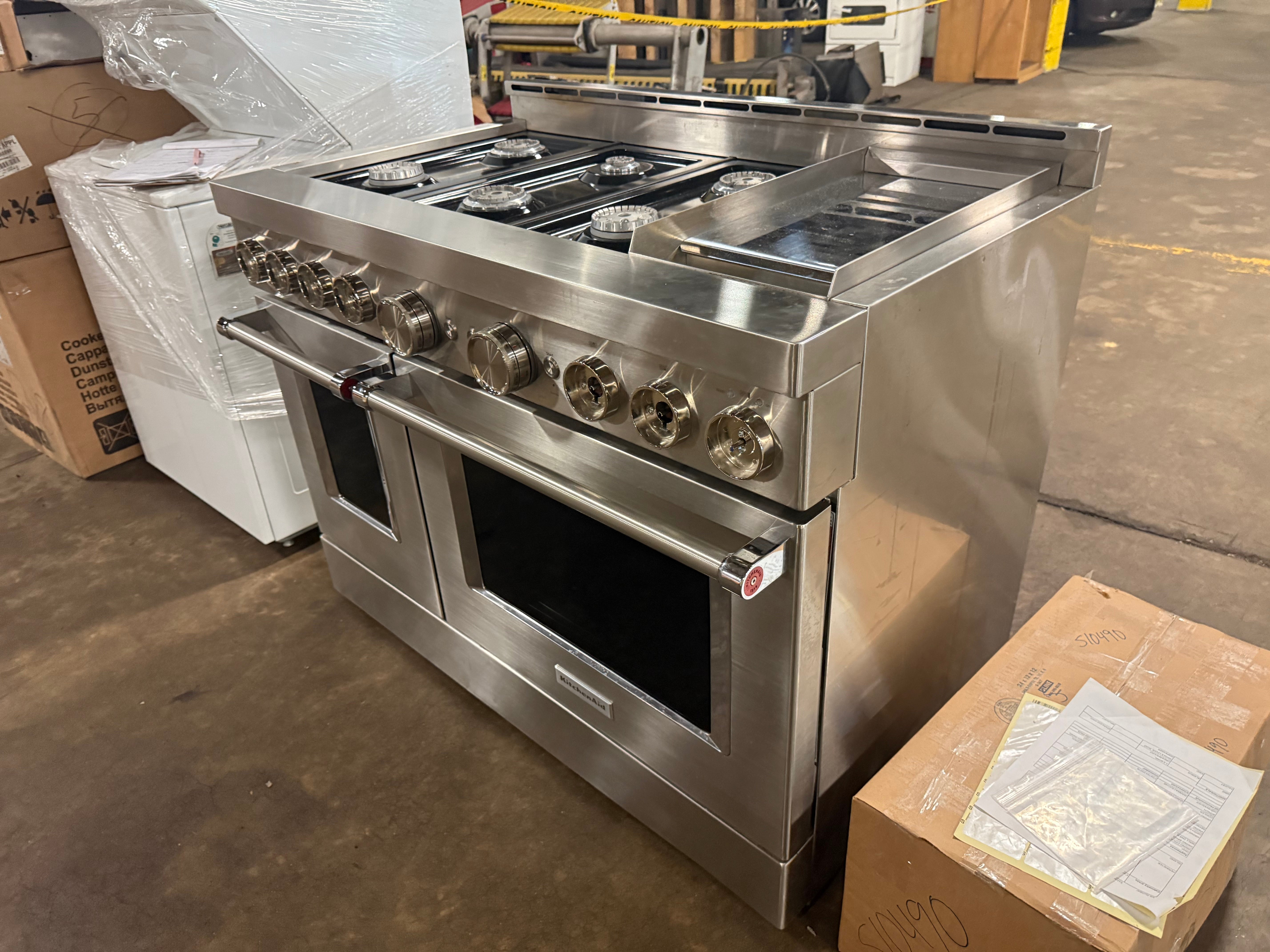 re owned KitchenAid 48 inch pro range open dual doors showing cobalt blue porcelain interiors