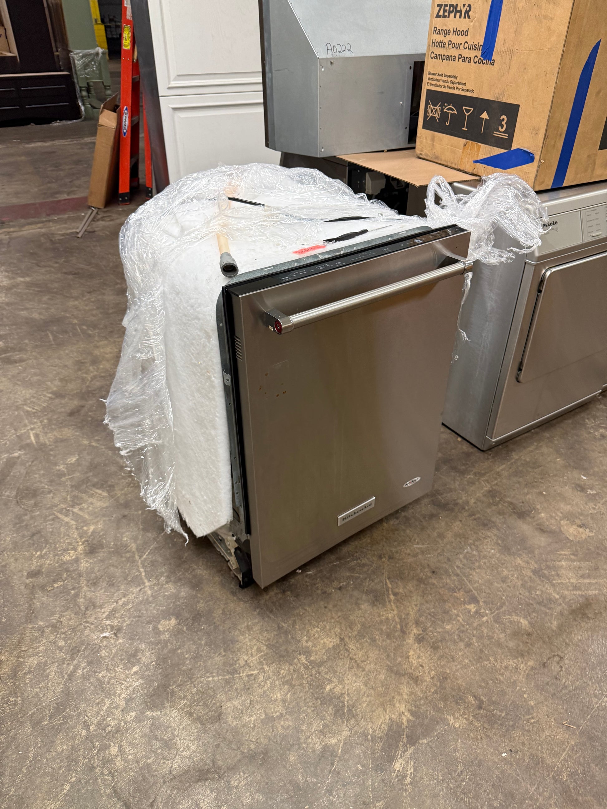 Integrated stainless steel top control dishwasher installed flush within professional luxury cabinetry