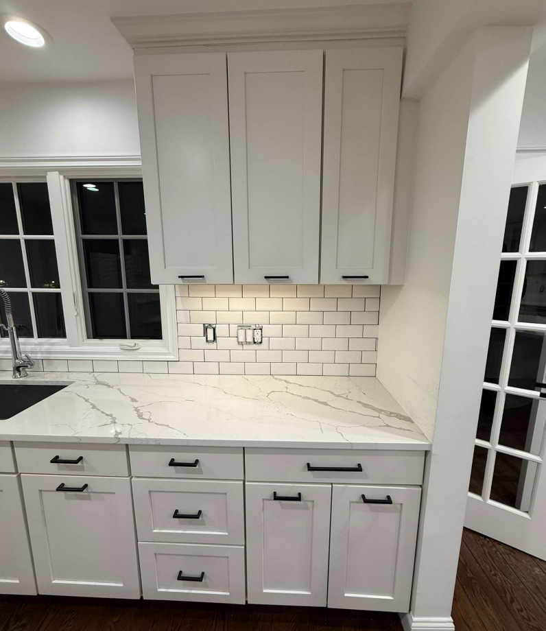 “The Westerly” Transitional White Kitchen with Island, 48" Sub-Zero Refrigerator and Bosch Appliances