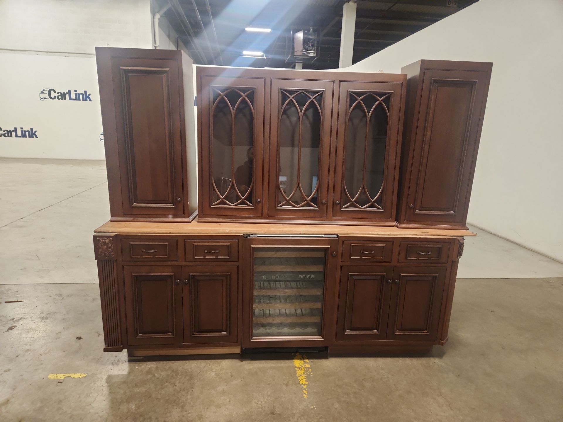 Luxury wooden pantry cabinetry featuring wine storage and display shelving