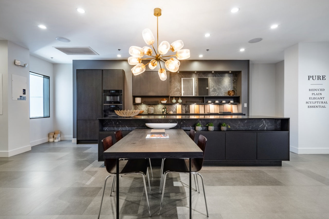 Luxury showroom matte black German kitchen set with integrated Miele appliances