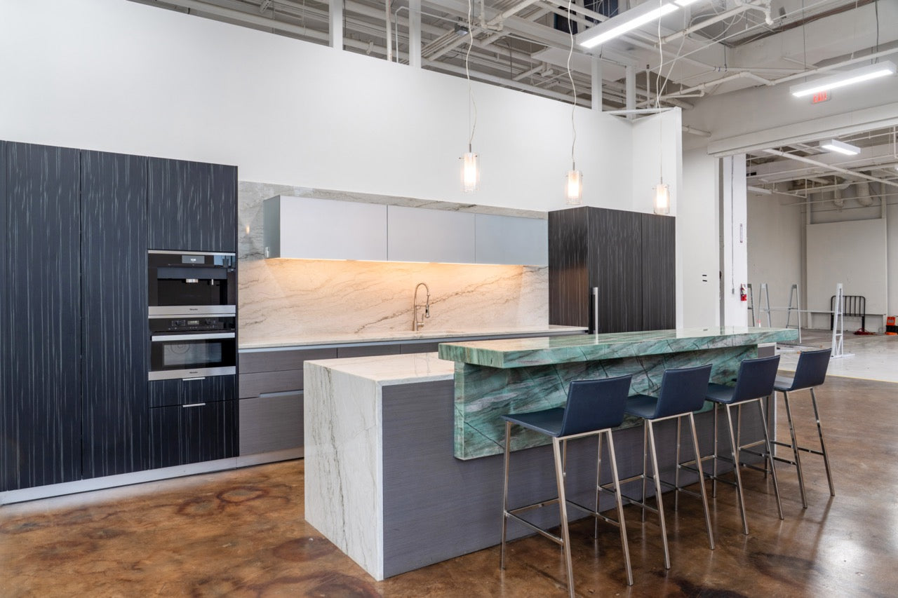 Luxury German kitchen cabinetry with integrated Miele wall ovens and wood veneer