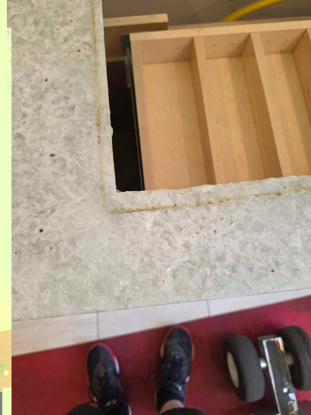 Aurora Circ light stone kitchen countertop with rectangular cutout above a wooden drawer box during installation