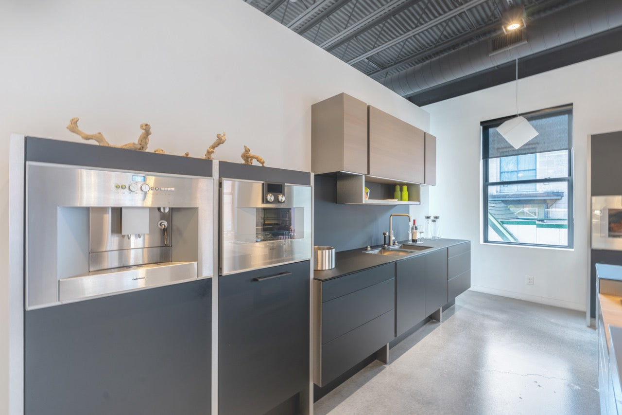 Poggenpohl Porsche Modern Matte Grey Kitchen with Wood Top Seating Area and Gaggenau Appliances