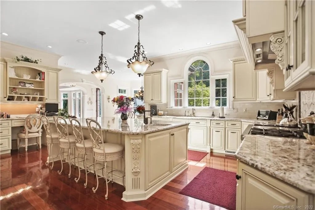 Luxury traditional cream kitchen cabinet layout showing integrated built in home office desk area