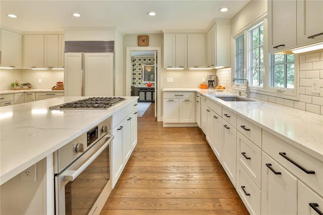 “The Westerly” Transitional White Kitchen with Island, 48" Sub-Zero Refrigerator and Bosch Appliances
