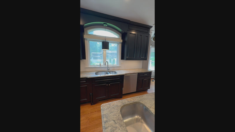 Luxury custom jet black kitchen cabinetry with professional appliances