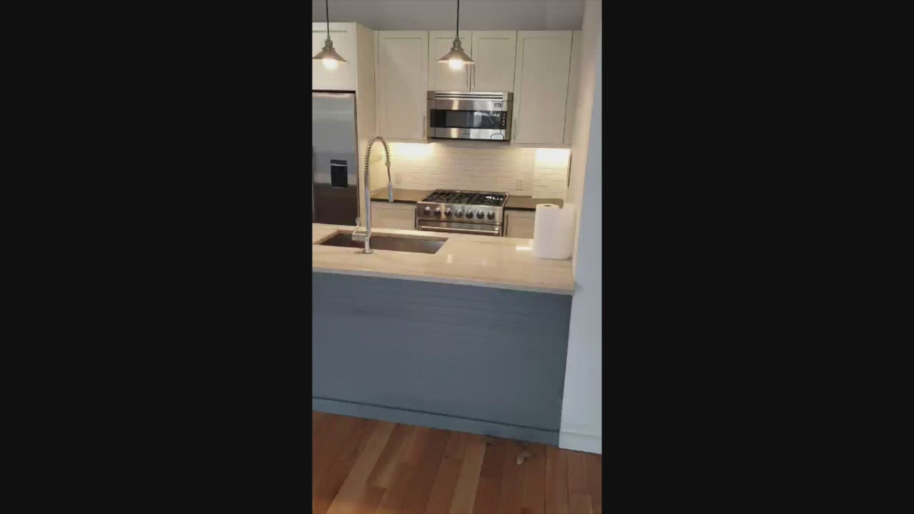 Load video: Imperia White Transitional Kitchen with Dark Grey Island, Marble &amp; Stone Counters and Appliances