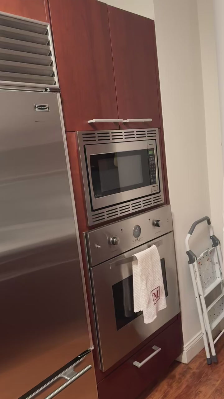 Load video: Poggenpohl Brown Toned Transitional Kitchen with Marble Countertops and Appliances