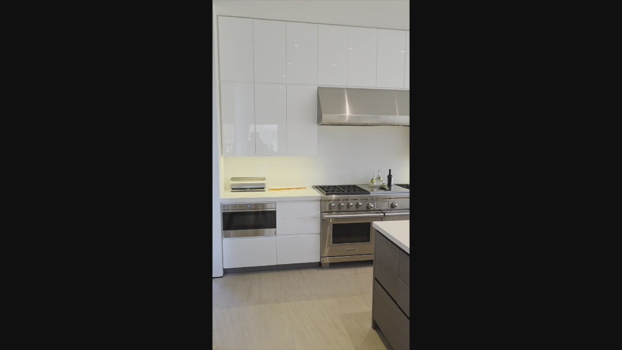 Load video: Custom Modern White Gloss Kitchen with Island, Stone Countertops and 60" Wolf Range