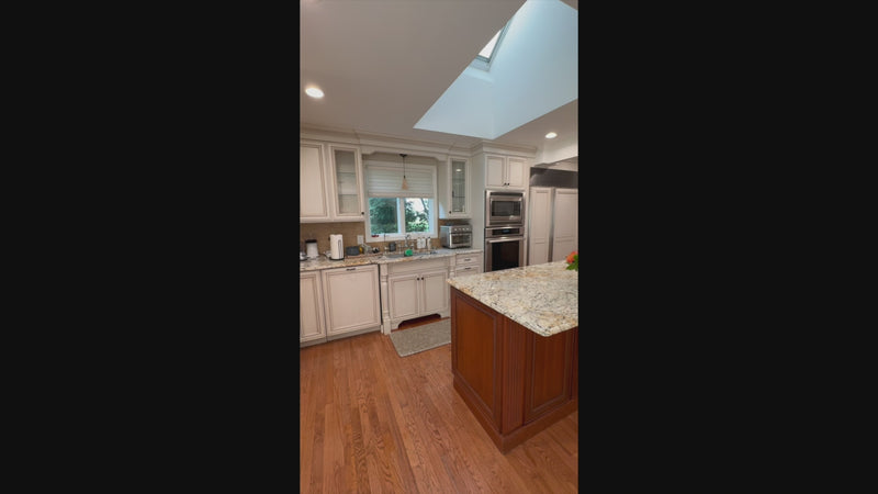 High-end architectural white kitchen suite with integrated home office workstati