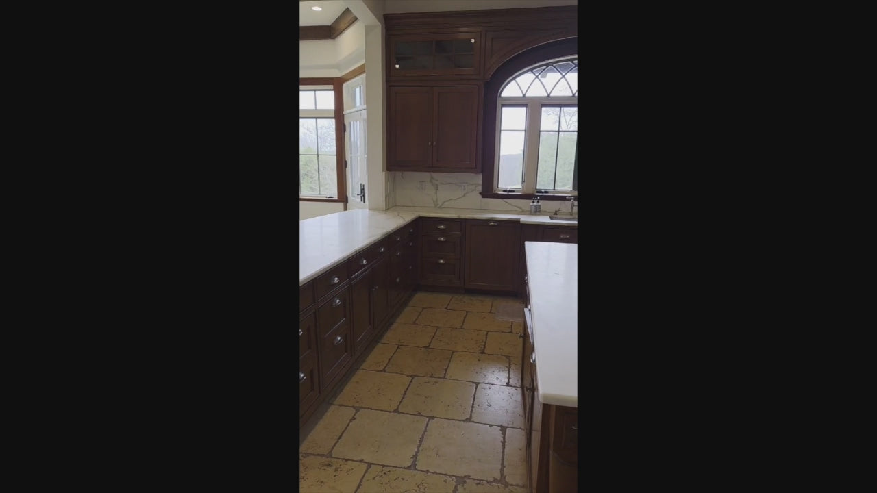 Load video: Luxury estate kitchen with rich wood cabinetry and ornate stone countertops
